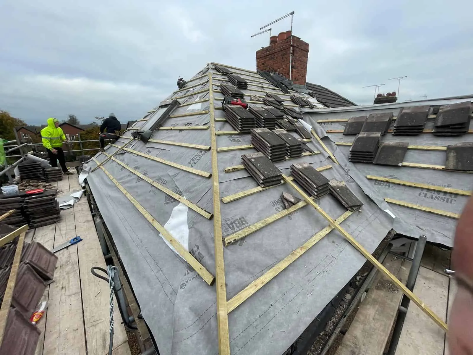 Dragon Elite roofers full re-roofing work on a pitched roof