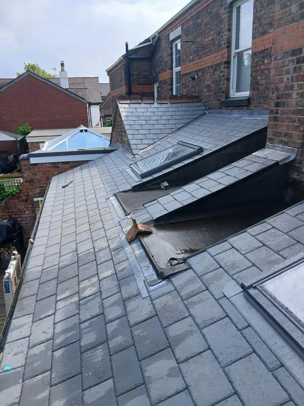 Flat roof sections on slate roof over kitchen extension