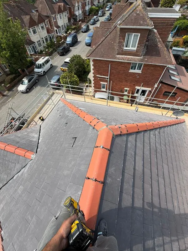 Slate tile replacements and dry ridge roofing on house in Shropshire