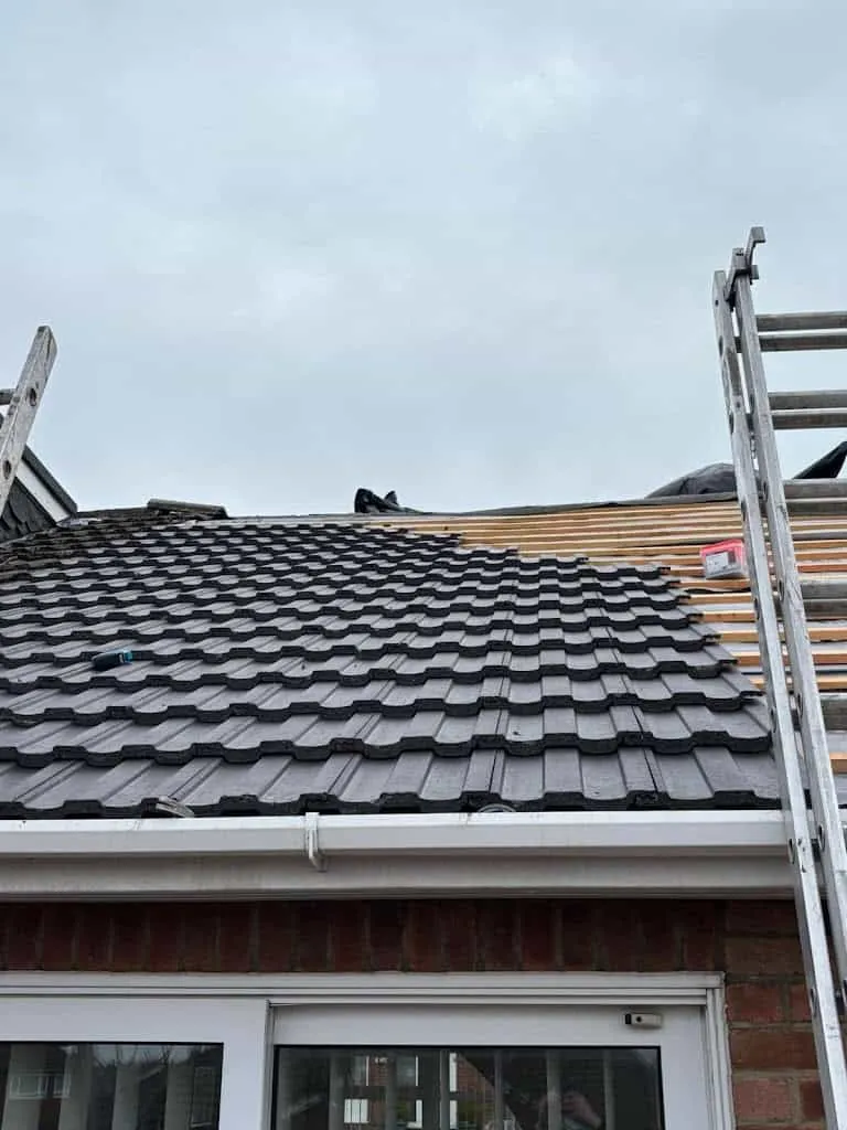 Roofing tiles being re-laid on a residential property
