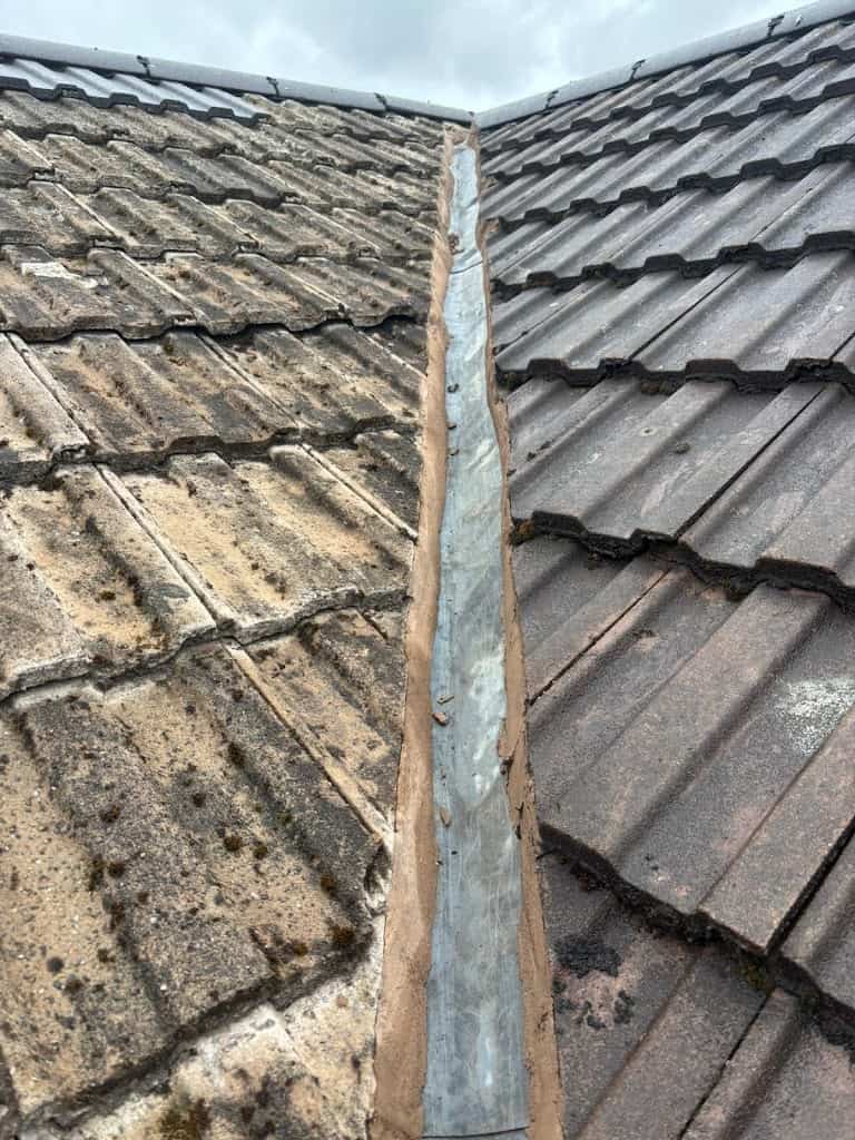 Photo showing repaired roof valley and new roof tiles vs old roof tiles