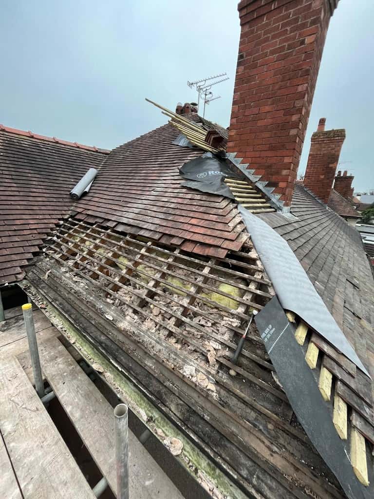 Re-roofing project with section of old tiles removed